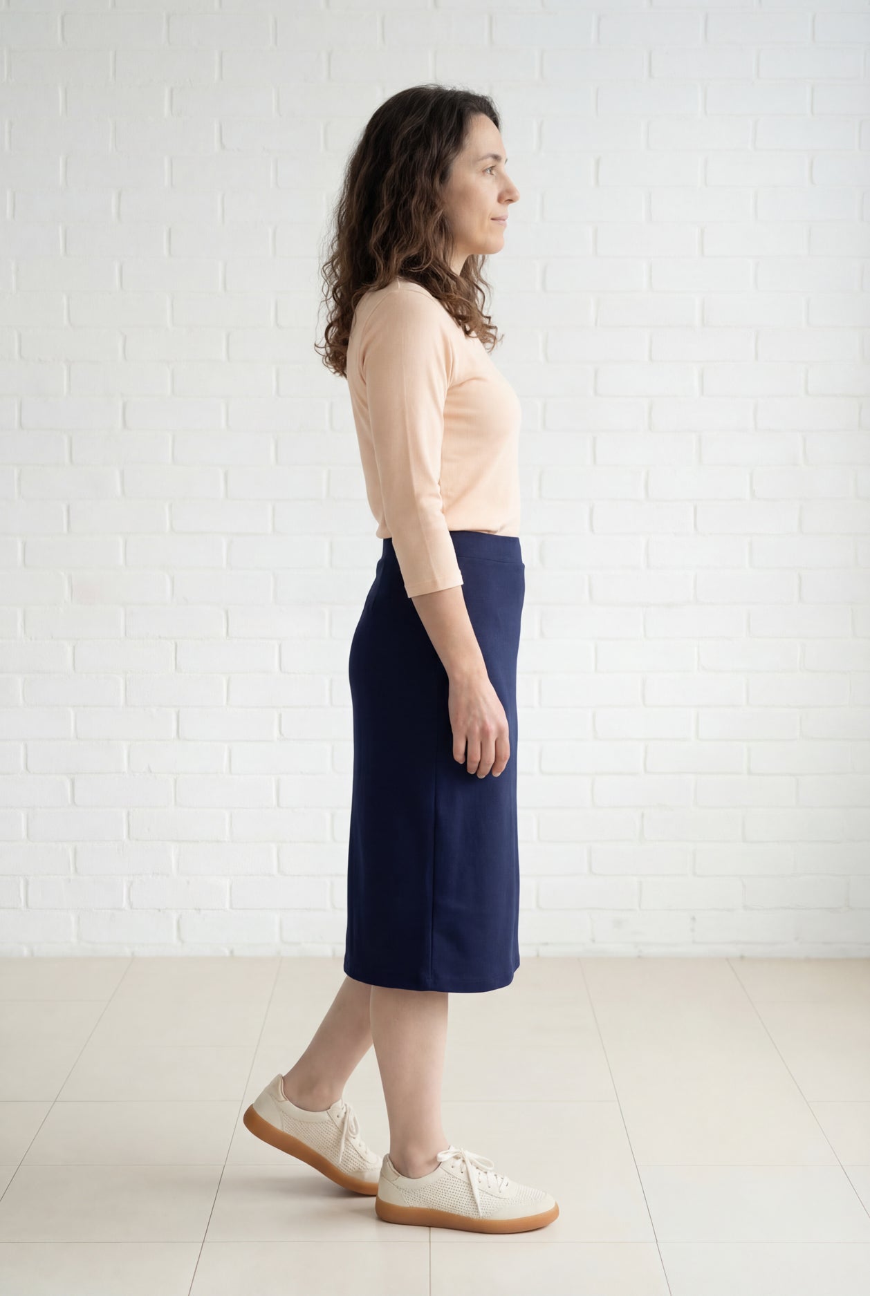Model wearing Nuggles® 27" Relaxed Midi Skirt in Navy