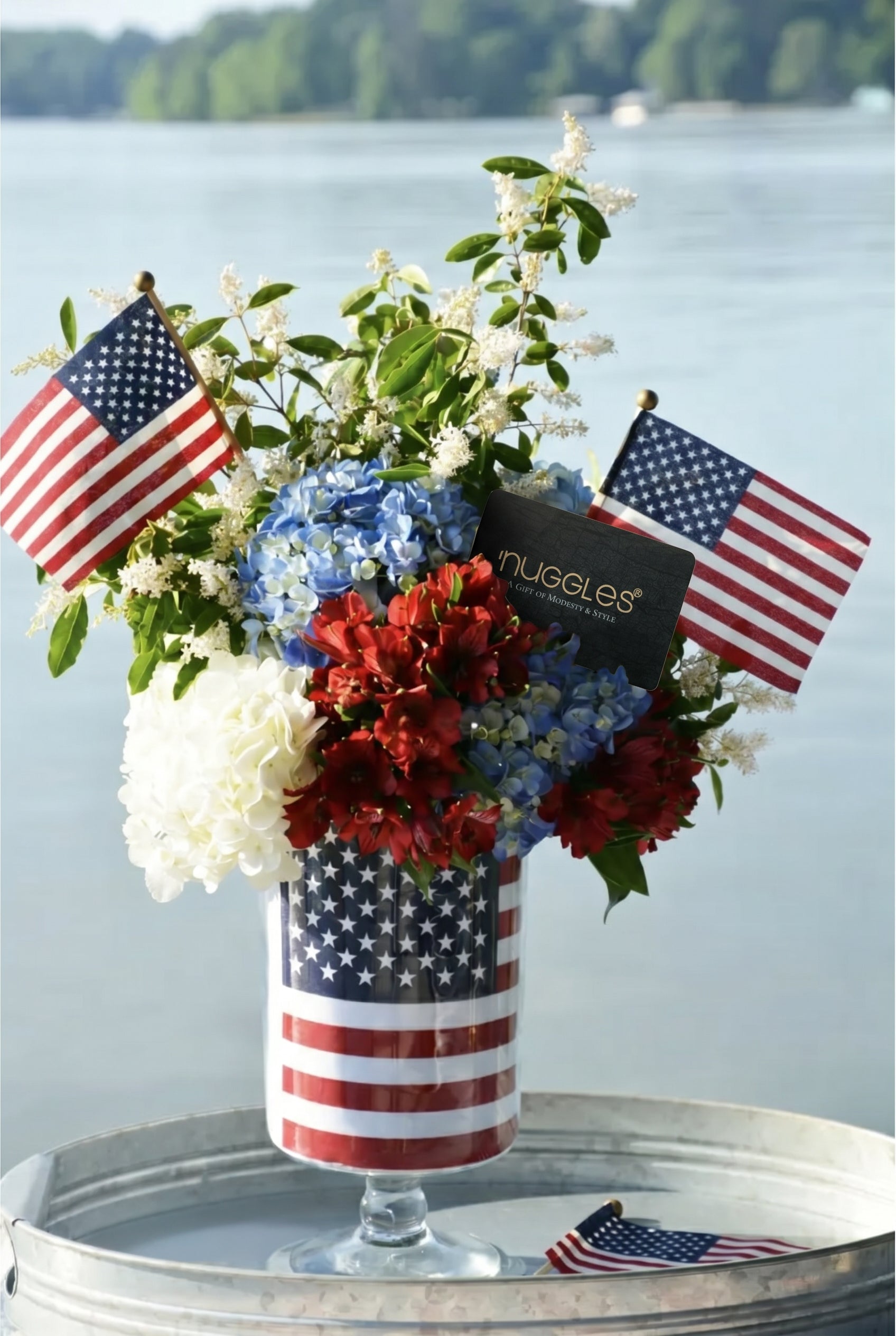 A picture of red, white, and blue flowers with American Flags and a Nuggles Gift Card.