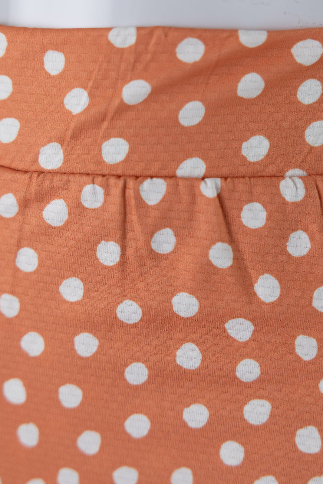 Model wearing Nuggles® 27" All-Sport Skirt in Orange Pop