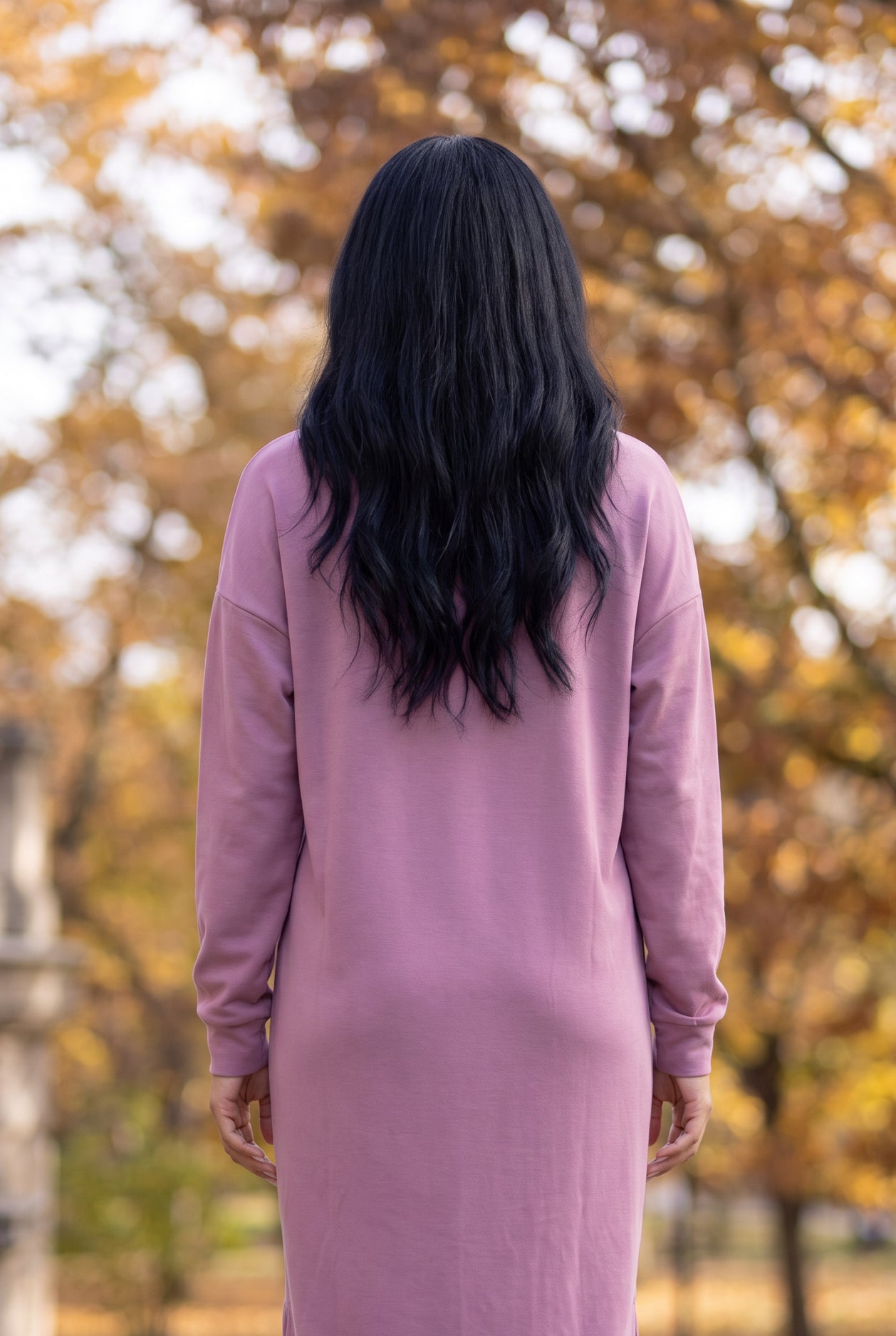 Nuggles® Oakley Hoodie Dress in Pale Purple, back view from the shoulders down against fall trees