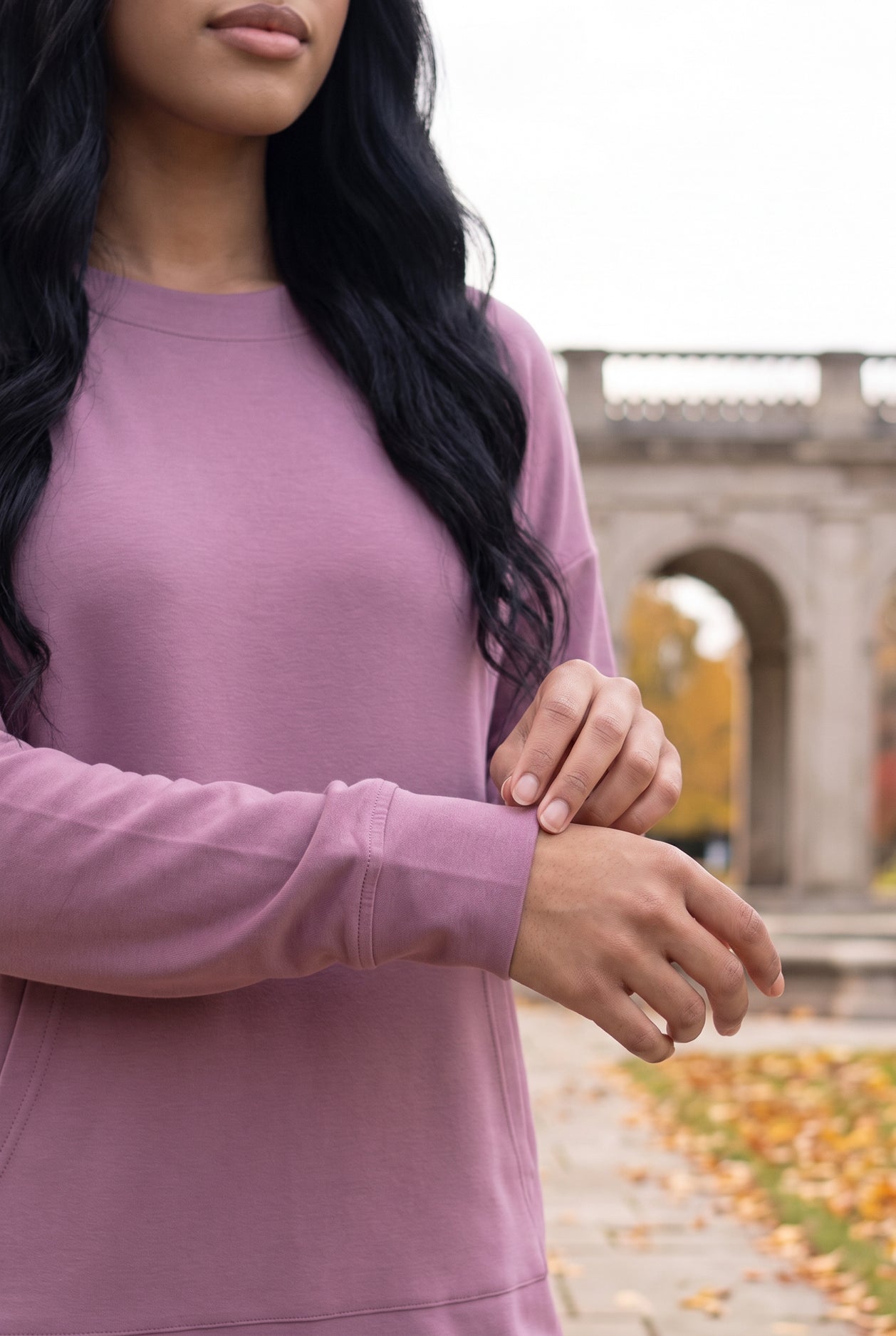 Nuggles® Oakley Hoodie Dress in Pale Purple, close-up of the ribbed sleeve cuff as she adjusts it