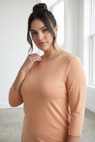Model wearing Nuggles® 3/4 Essential Tee in Peach