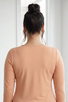 Model wearing Nuggles® 3/4 Essential Tee in Peach