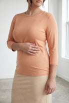 Model wearing Nuggles® 3/4 Essential Tee in Peach