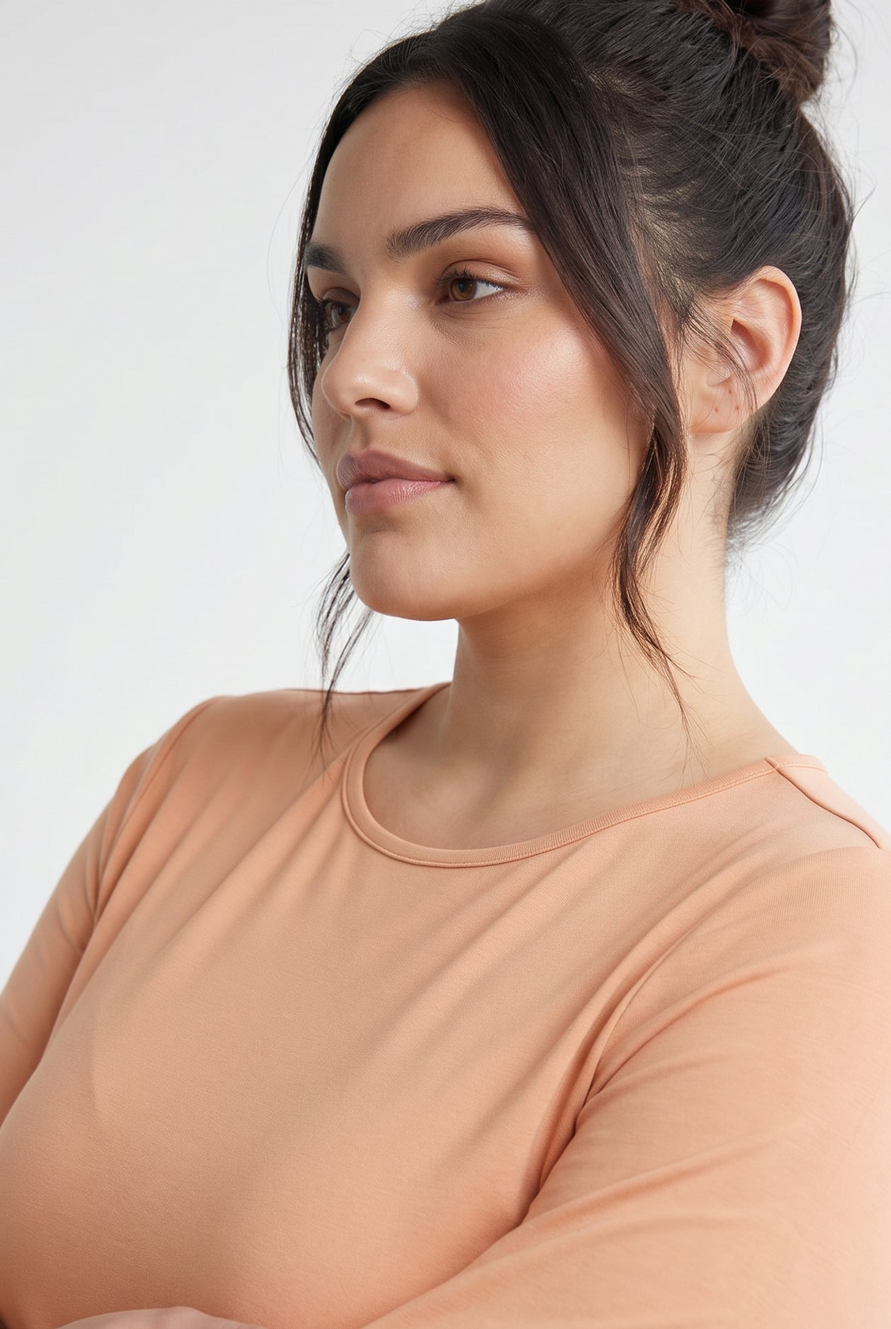 Model wearing Nuggles® 3/4 Essential Tee in Peach