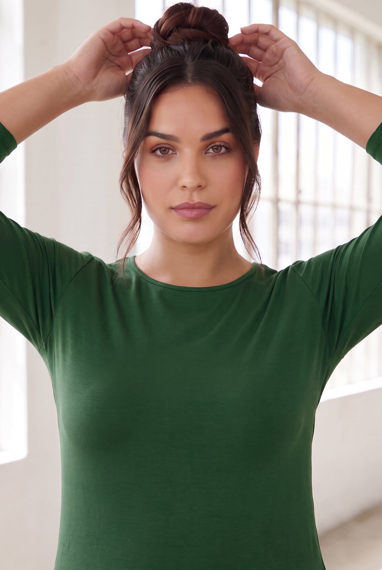 Model wearing Nuggles®  Essential  3/4 Tee in Pine Green