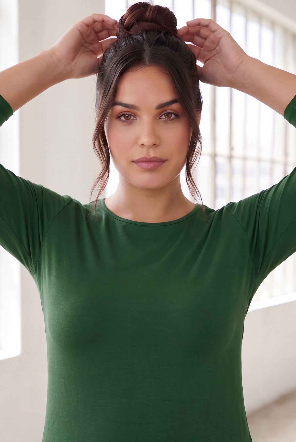 Model wearing Nuggles®  Essential  3/4 Tee in Pine Green