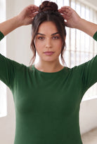 Model wearing Nuggles®  Essential  3/4 Tee in Pine Green