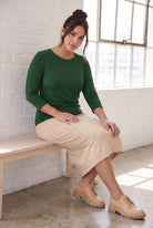 Model wearing Nuggles®  Essential  3/4 Tee in Pine Green