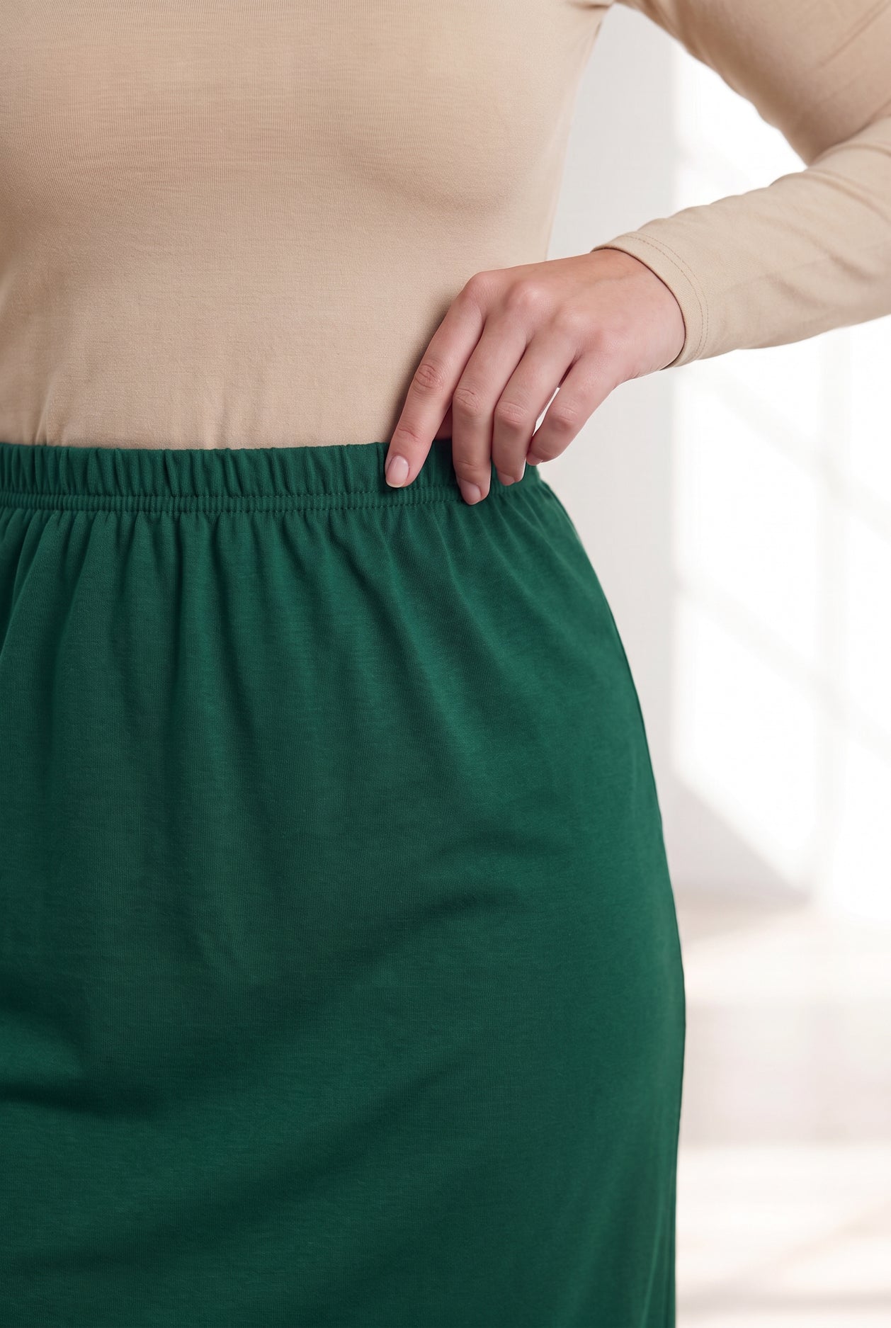 Model wearing Nuggles® 31" Classic Skirt in Pine Green