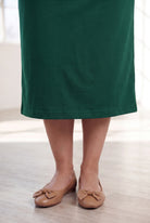 Model wearing Nuggles® 31" Classic Skirt in Pine Green