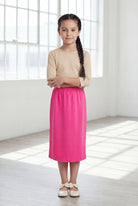 Model wearing Nuggles®  Girls Classic Skirt in Pink