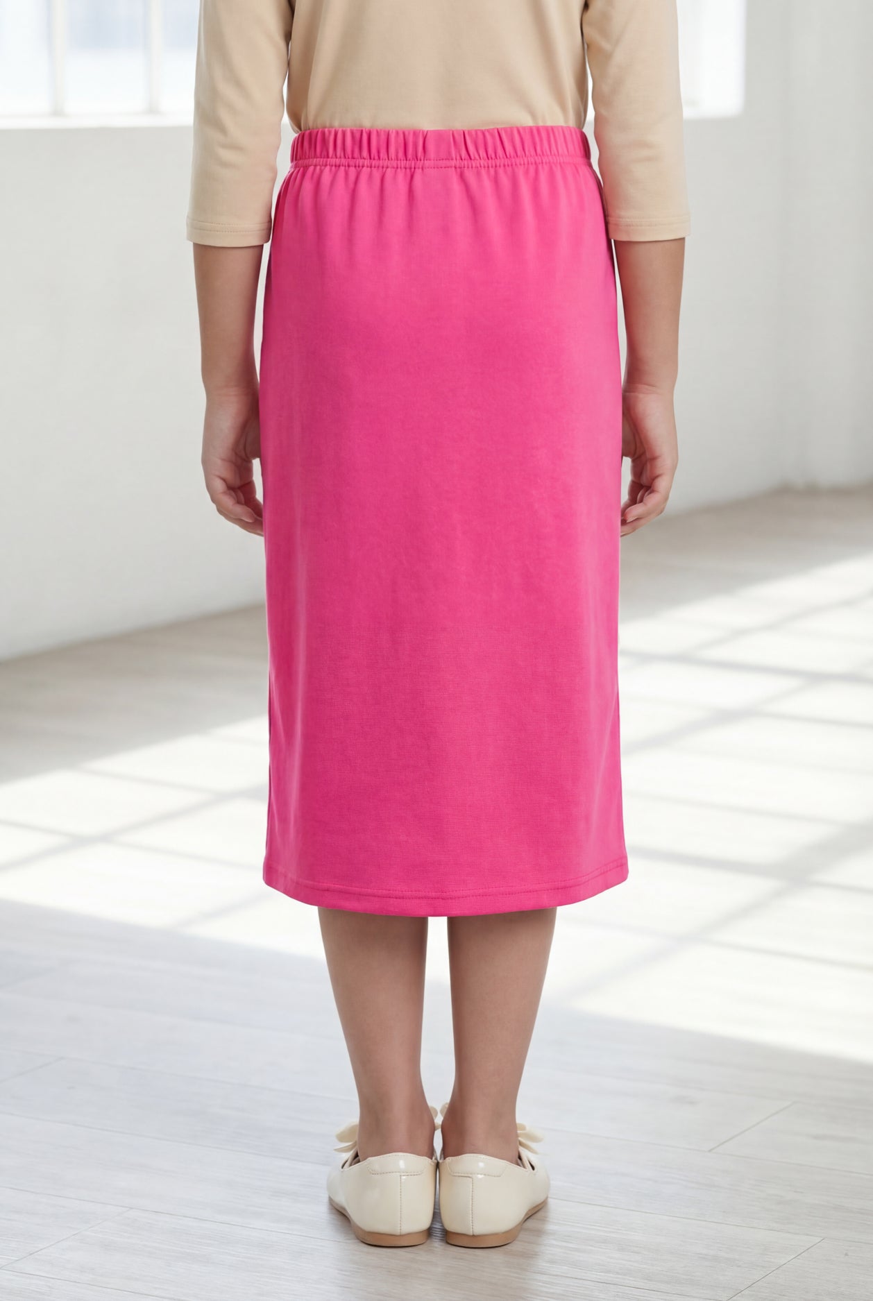 Model wearing Nuggles®  Girls Classic Skirt in Pink