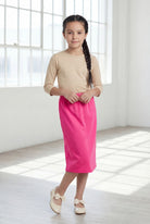 Model wearing Nuggles®  Girls Classic Skirt in Pink