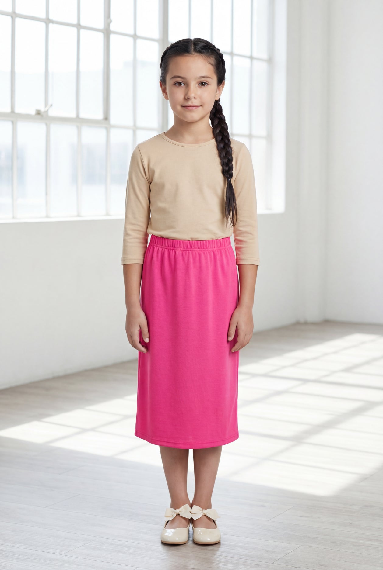 Model wearing Nuggles®  Girls Classic Skirt in Pink