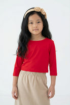 Model wearing the Girls' Nuggles® Essential 3/4 Tee in Red