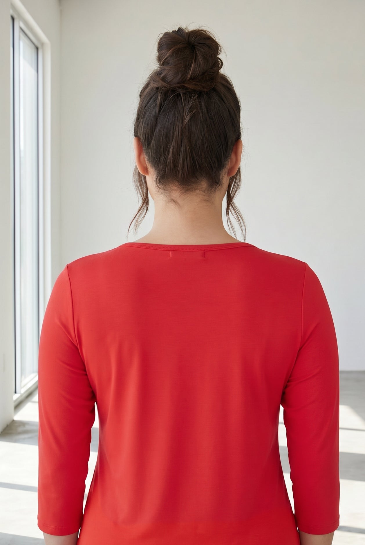 Model wearing Nuggles® 3/4 Essential Tee in Red