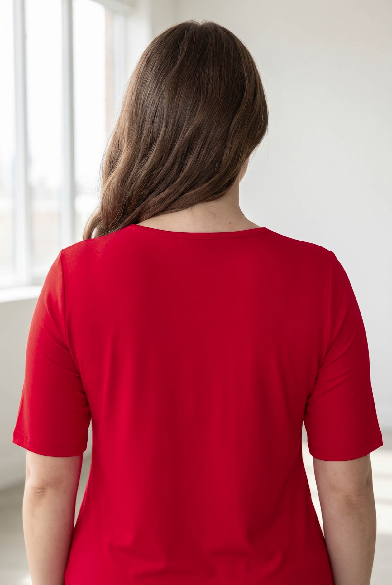 Model wearing the Nuggles® Essential Half Sleeve Tee in Red 