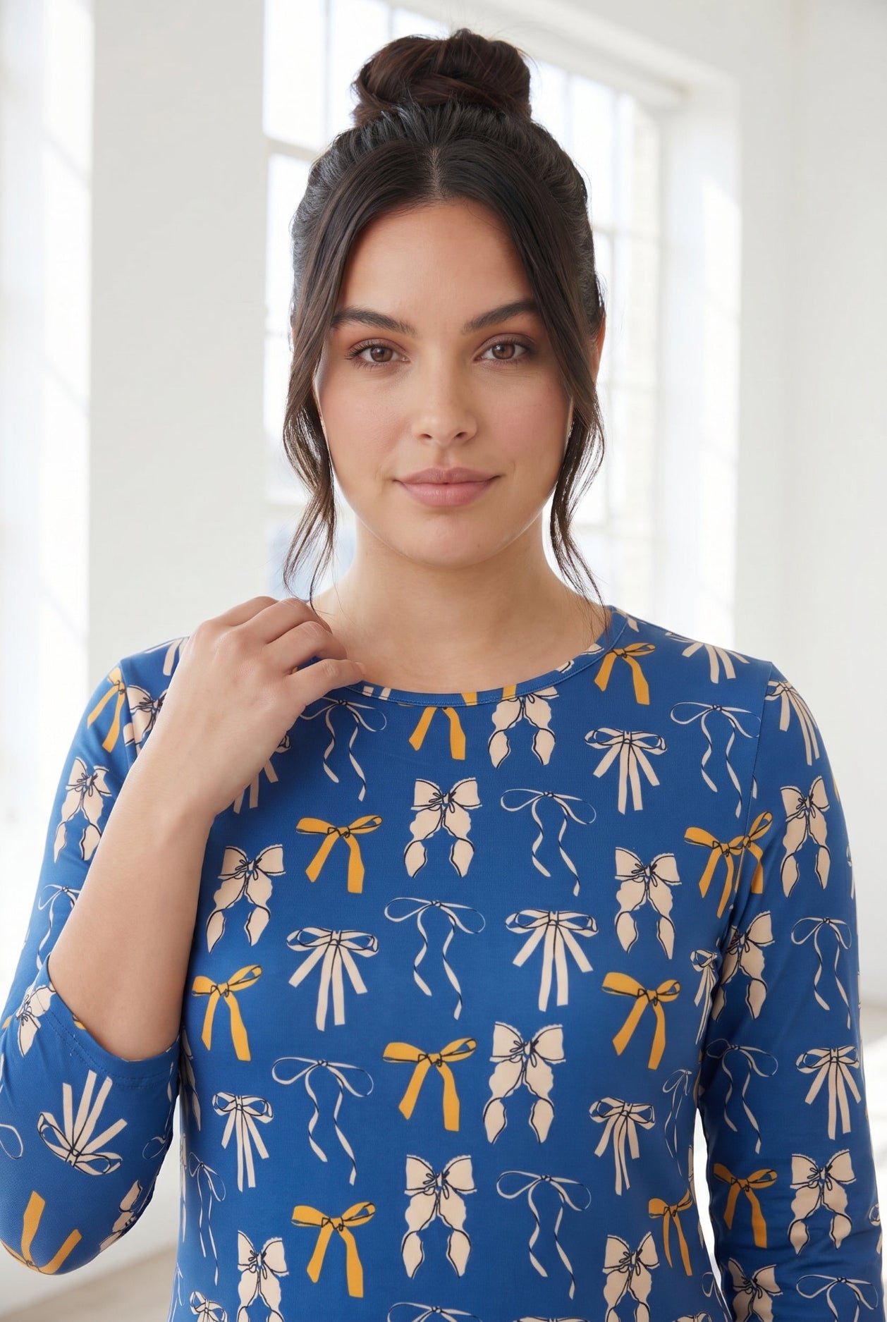 Model wearing Nuggles® 3/4 Essential Tee in Ribbon Day