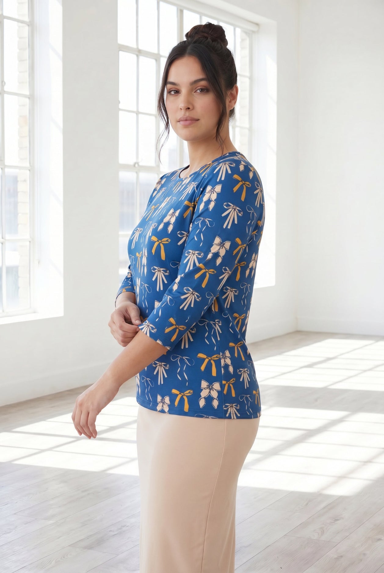Model wearing Nuggles® 3/4 Essential Tee in Ribbon Day
