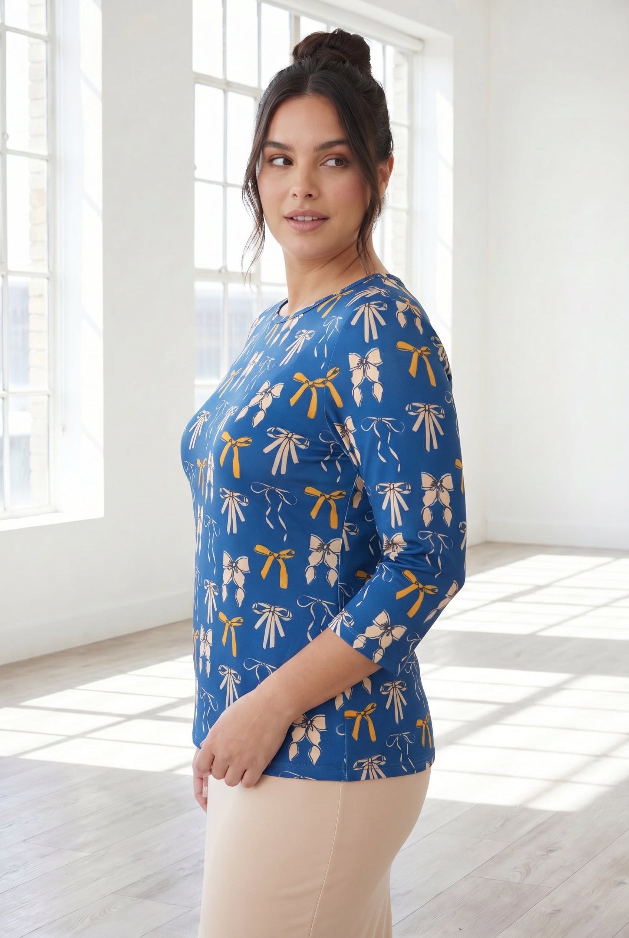 Model wearing Nuggles® 3/4 Essential Tee in Ribbon Day