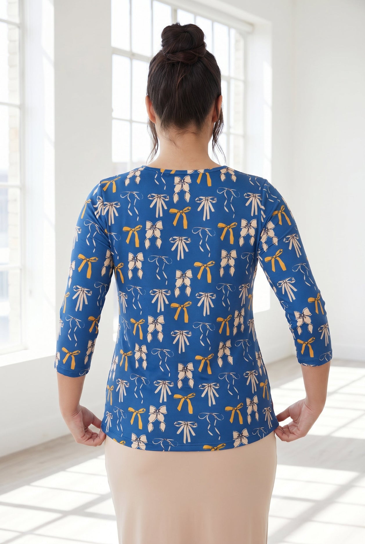 Model wearing Nuggles® 3/4 Essential Tee in Ribbon Day
