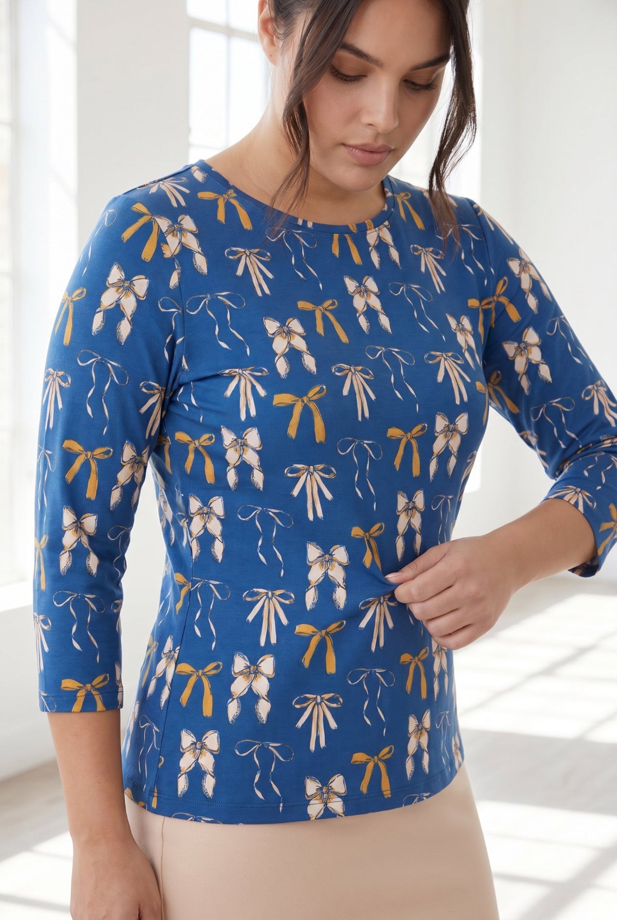 Model wearing Nuggles® 3/4 Essential Tee in Ribbon Day