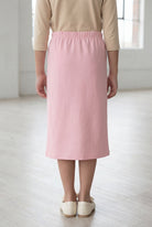 Model wearing the Nuggles® Girls' Classic Midi Skirt in Rose