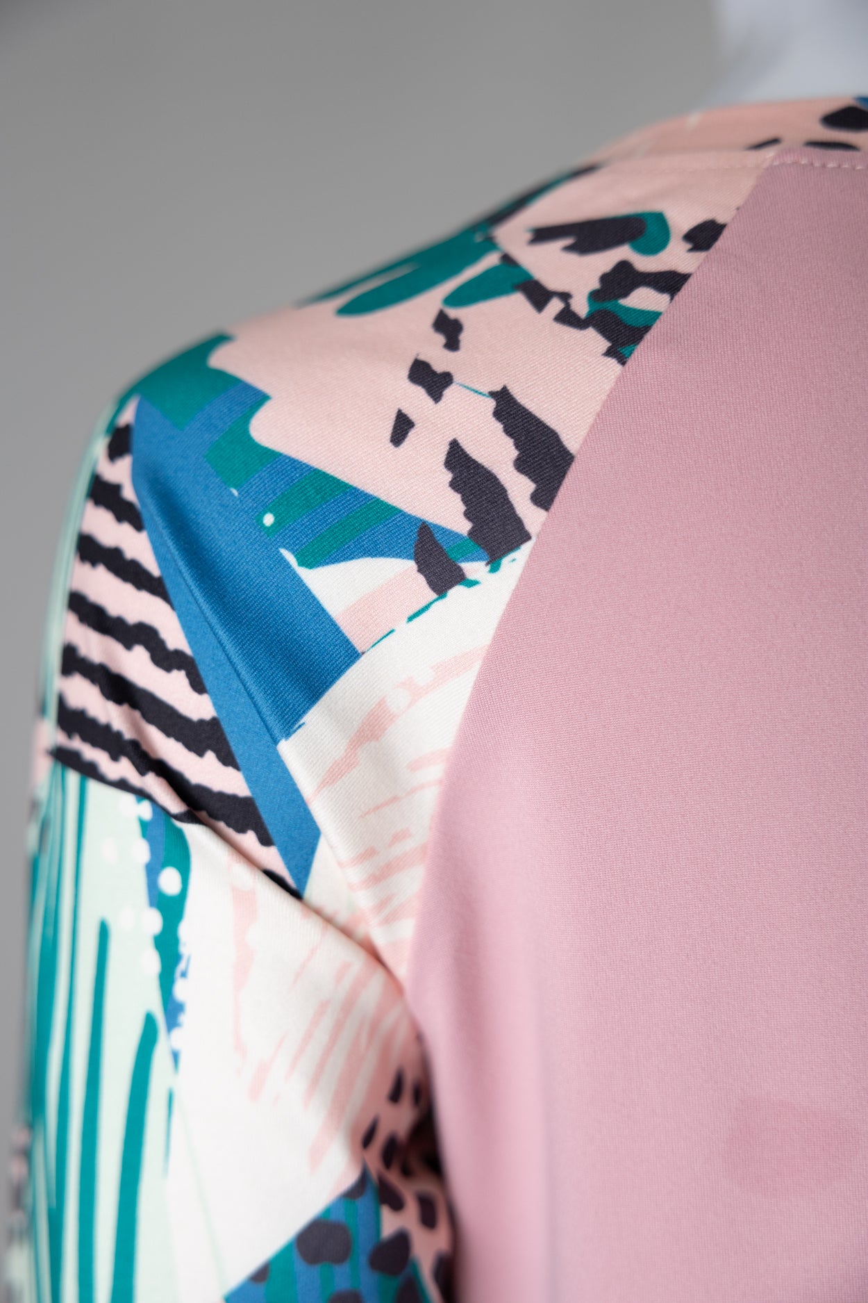 A close up picture of a pink 3/4 sleeve top. 
