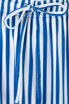 Close-up of blue and white striped skirt with a tie waist.