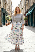 Person wearing a maxi skirt with a bow pattern. 