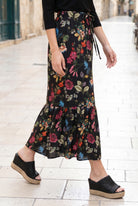 Person wearing a floral skirt on a city street