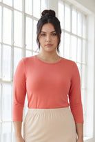 Model wearing Nuggles® 3/4 Essential Tee in Salmon