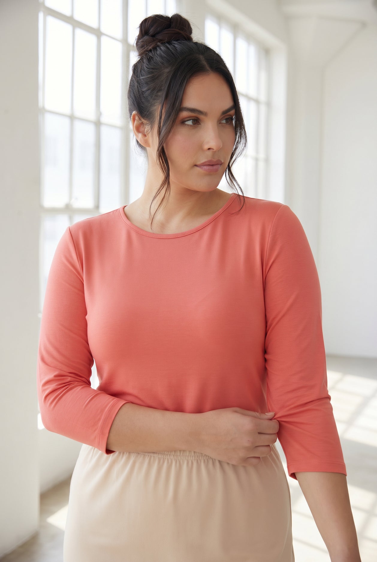 Model wearing Nuggles® 3/4 Essential Tee in Salmon