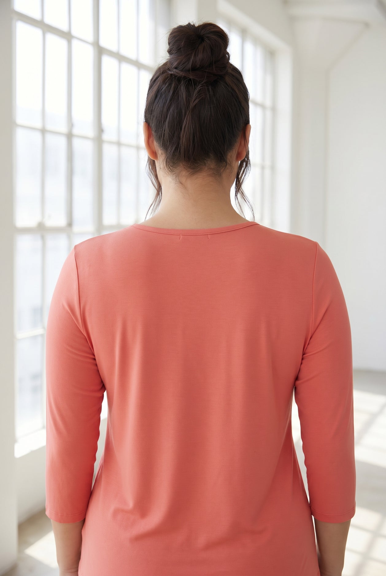 Model wearing Nuggles® 3/4 Essential Tee in Salmon