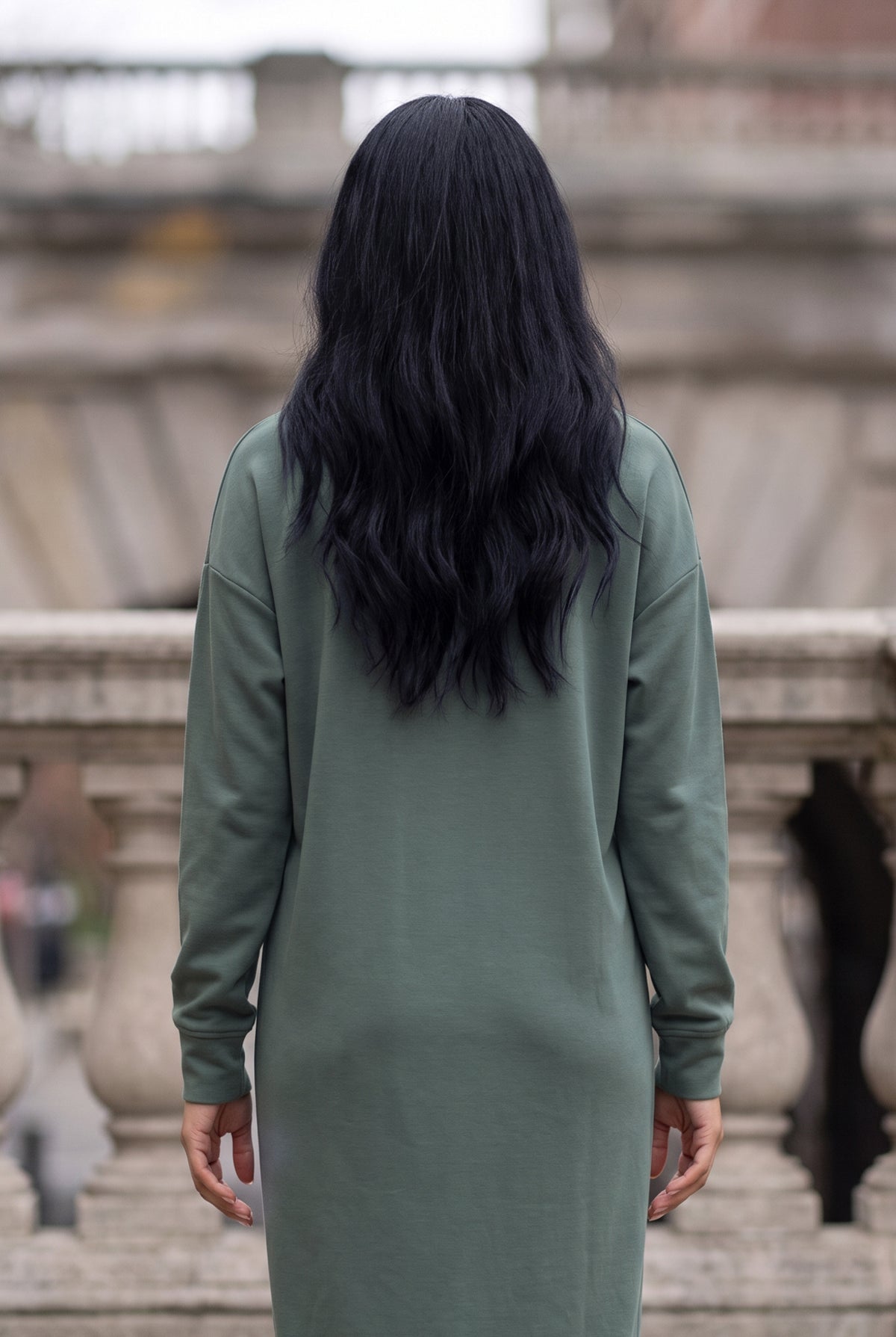 Nuggles® Oakley Hoodie Dress in Steel Blue, back view from the shoulders down in front of a stone balustrade
