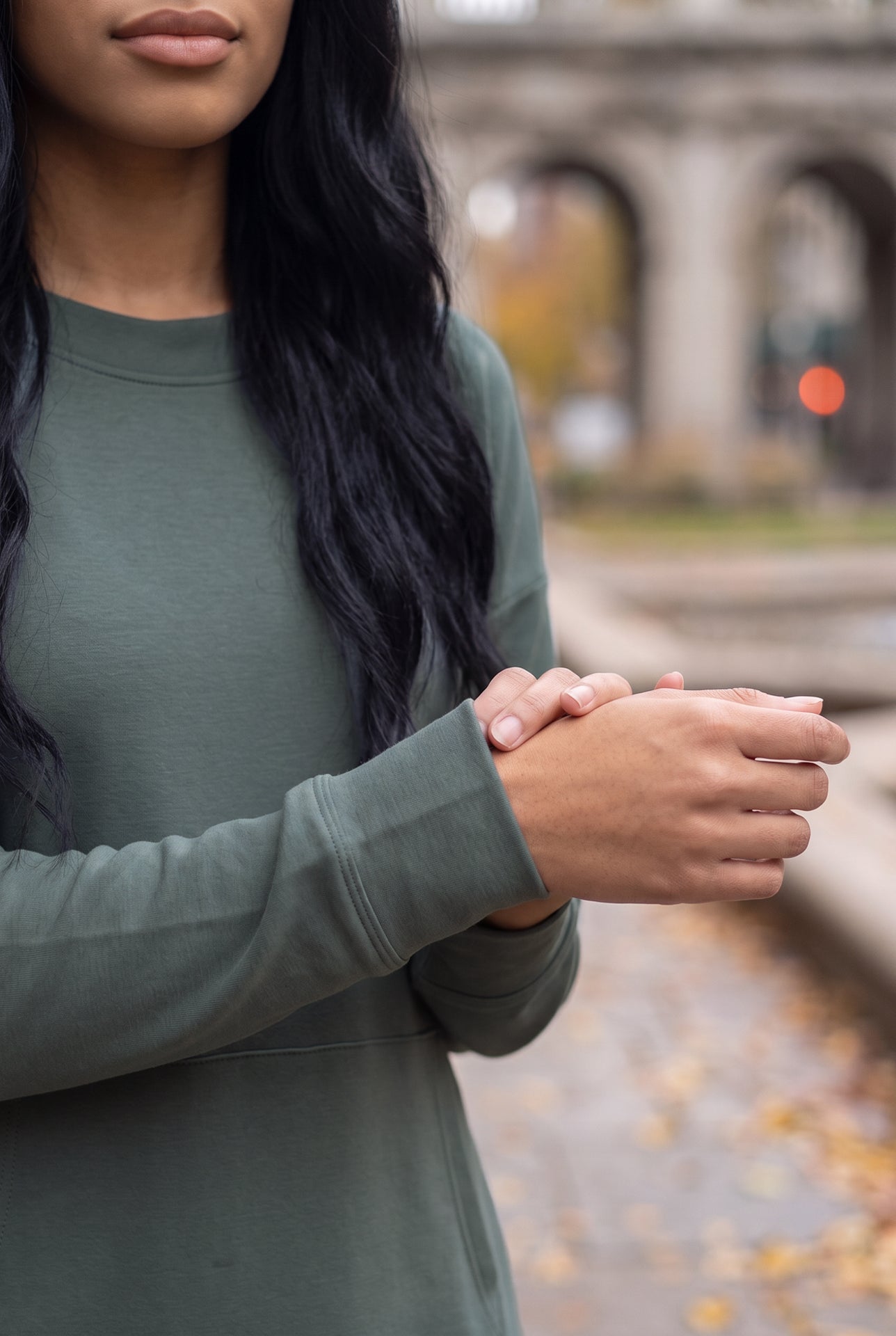 Nuggles® Oakley Hoodie Dress in Steel Blue, close-up of the ribbed sleeve cuff with hands clasped at the waist