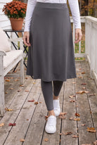 Nuggles® Tilly Sport Skirt in Slate Grey, waist-down front view standing with both hands relaxed at her sides