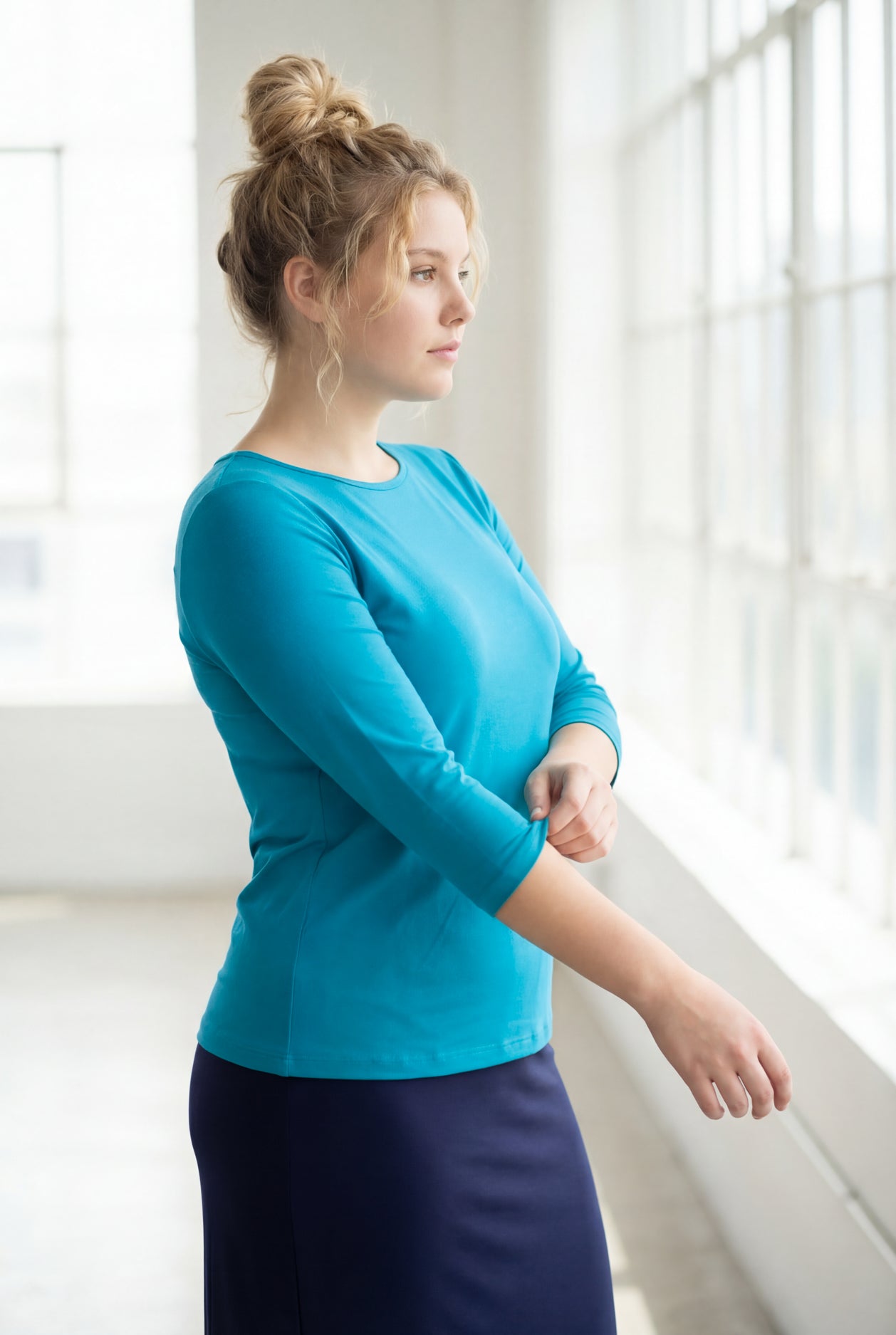 Model wearing the Nuggles® Essential 3/4 Tee in Teal