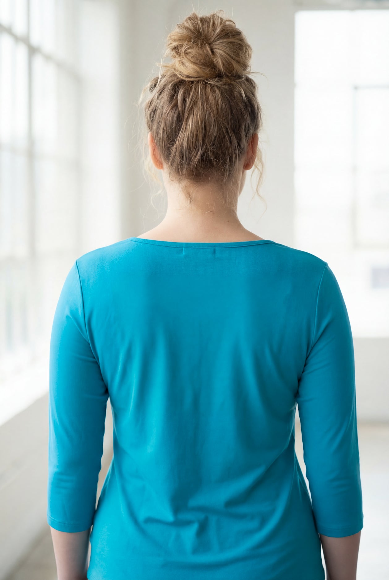 Model wearing the Nuggles® Essential 3/4 Tee in Teal