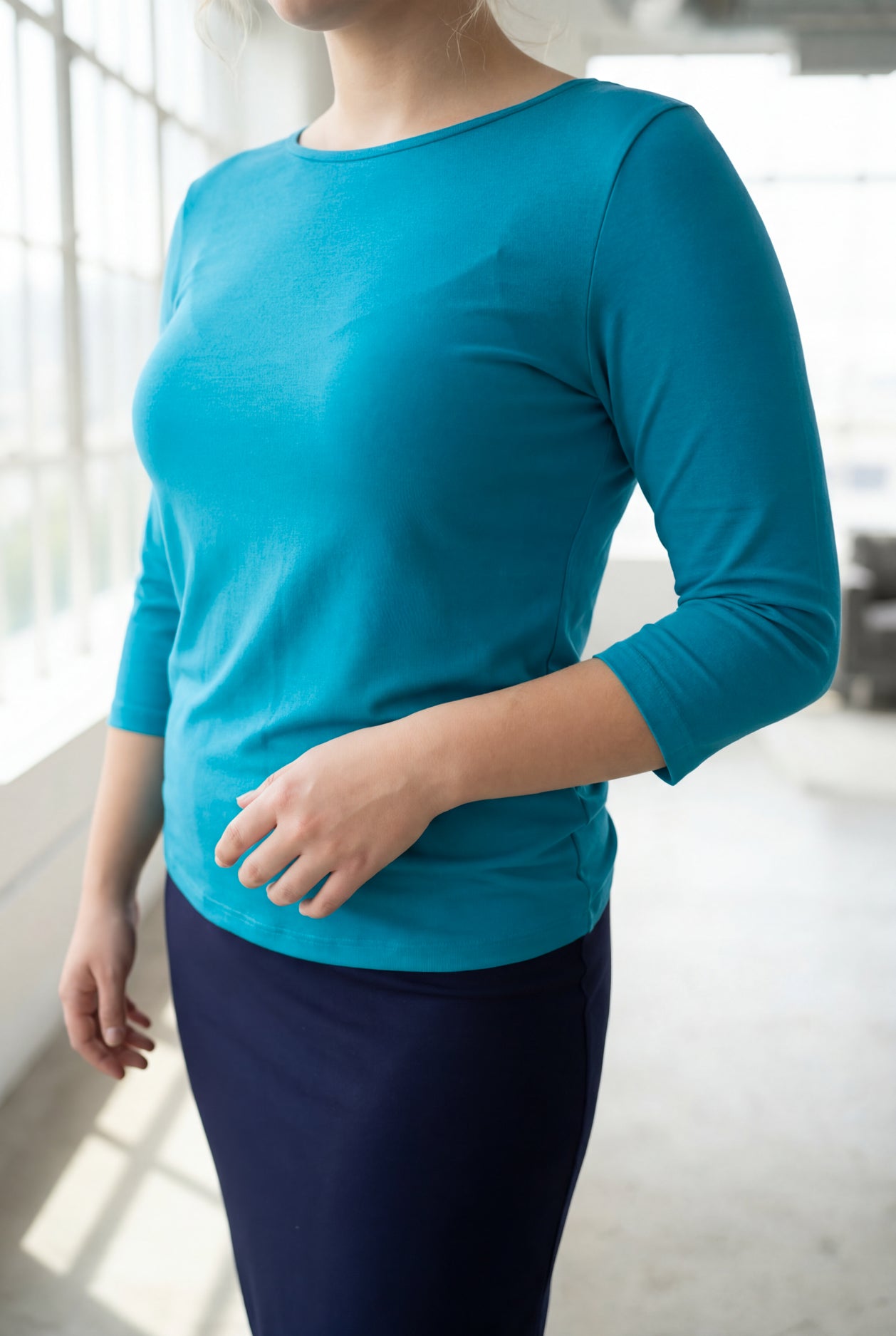 Model wearing the Nuggles® Essential 3/4 Tee in Teal
