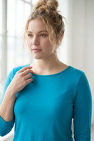 Model wearing the Nuggles® Essential 3/4 Tee in Teal