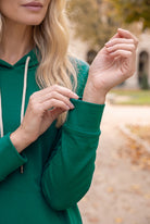 Model wearing Nuggles®   Hoodie Dress in Teal Green
