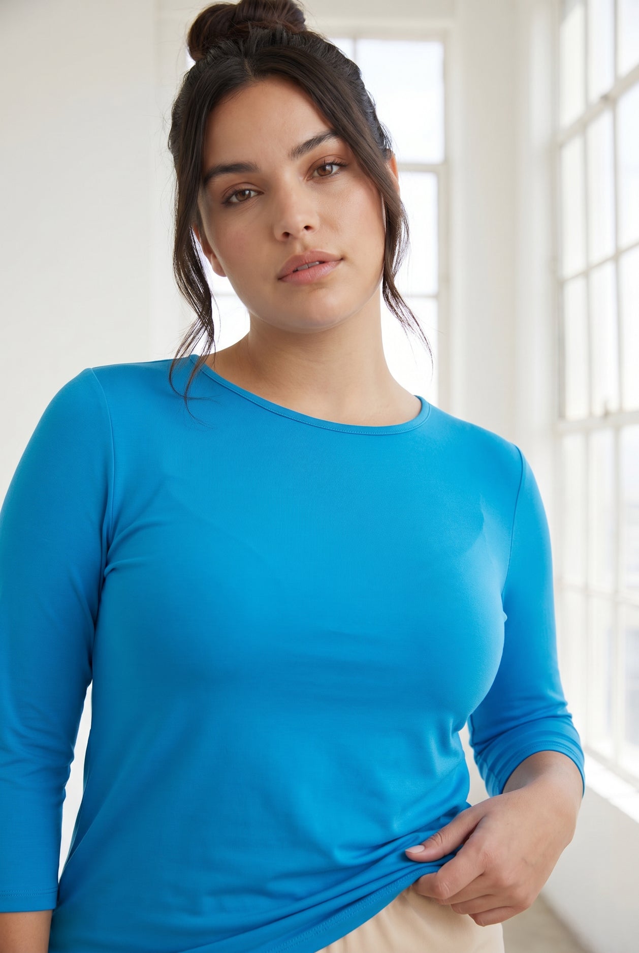 Model wearing Nuggles® 3/4 Essential Tee in Turquoise