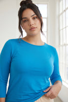 Model wearing Nuggles® 3/4 Essential Tee in Turquoise