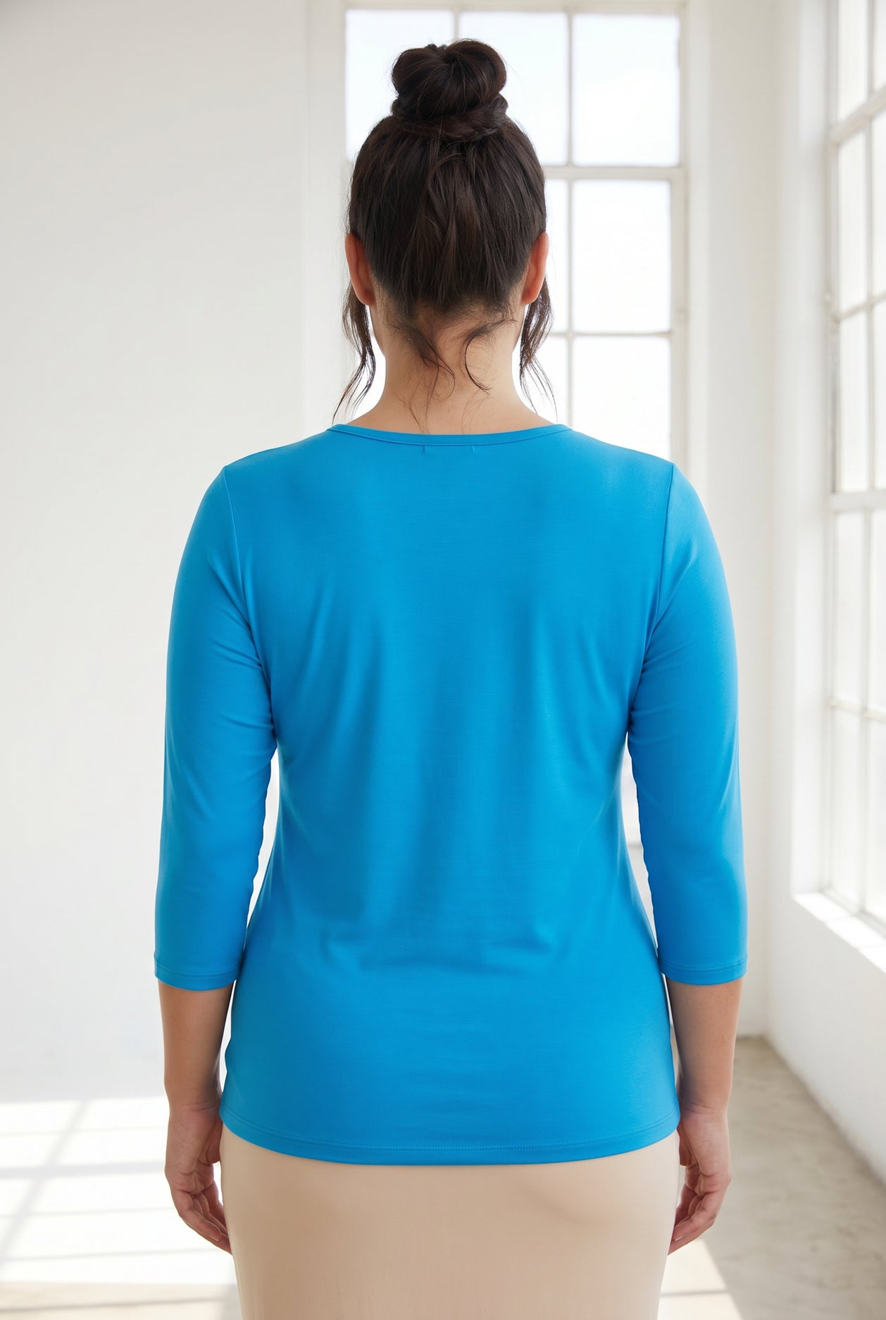 Model wearing Nuggles® 3/4 Essential Tee in Turquoise