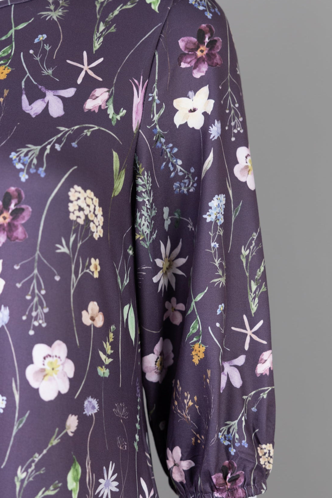 Nuggles® Patricia Dress in Twilight Garden, detail of the wildflower print with pink ruffle trim