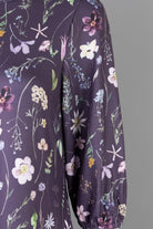 Nuggles® Patricia Dress in Twilight Garden, detail of the wildflower print with pink ruffle trim