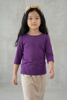 Model wearing the Girls' Nuggles® Essential 3/4 Tee in Violet