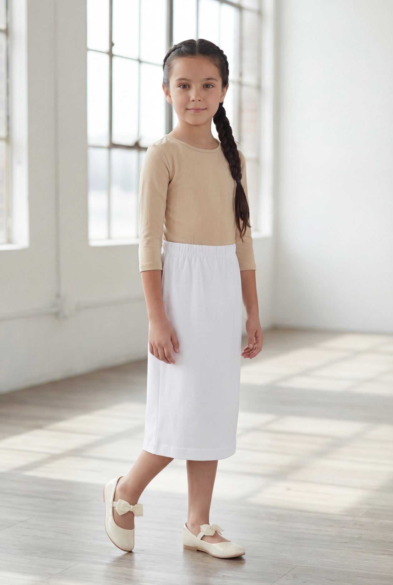 Model wearing Nuggles®  Girls Classic Skirt in White